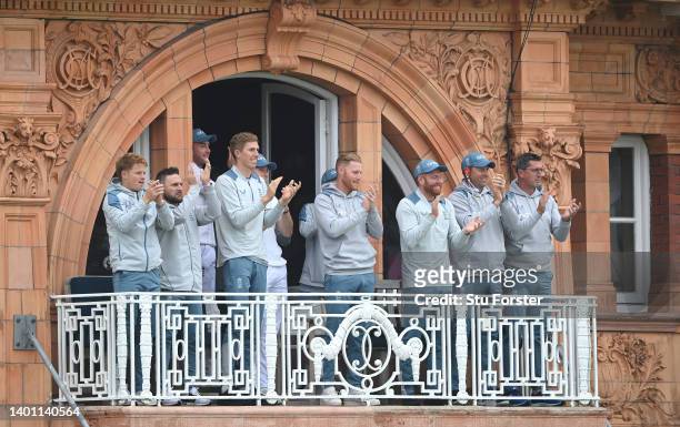 The England balcony including captain Ben Stokes and coach Brendon McCullum applaud Joe Root on his century during day four of the first Test Match...