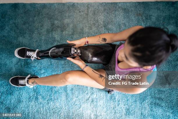 disabled mid adult woman getting dressed - artificial limb stock pictures, royalty-free photos & images