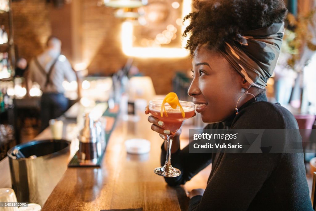 African woman having a cocktail