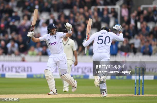 Joe Root of England and Ben Foakes of England celebrates the winning runs during day four of the First LV= Insurance Test match between England and...