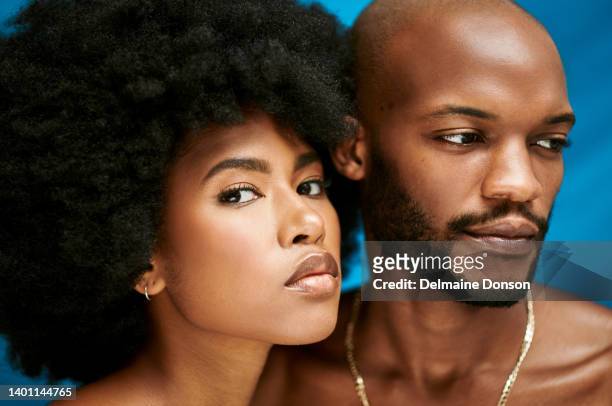 closeup of two models in a studio promoting clear skin. portrait of an african millennial couple with their faces close to each other while standing against a blue background - ideal wife bildbanksfoton och bilder