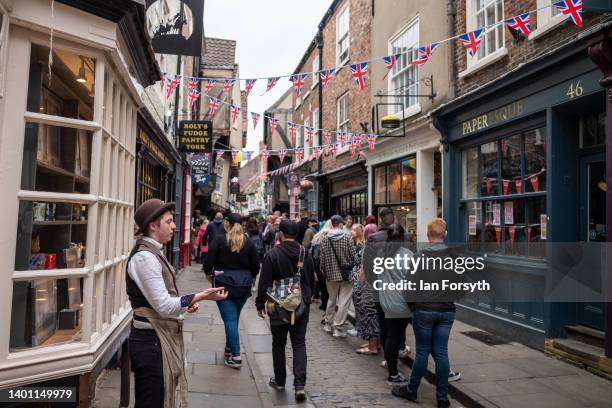 Visitors to York walk down the famous Shambles street on June 05, 2022 in York, England. The Platinum Jubilee of Elizabeth II is being celebrated...