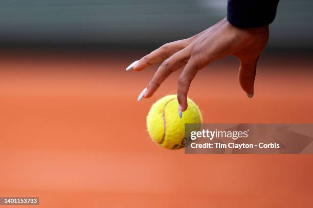 The hands of Coco Gauff of the United States bouncing the ball in preparatioin to servie on Court Philippe Chatrier at the 2022 French Open Tennis...