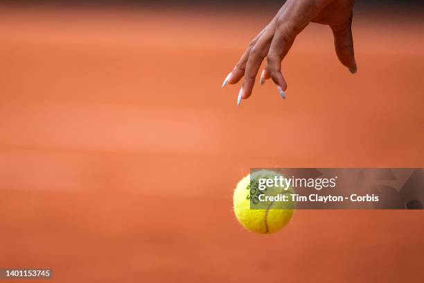 The hands of Coco Gauff of the United States bouncing the ball in preparatioin to servie on Court Philippe Chatrier at the 2022 French Open Tennis...