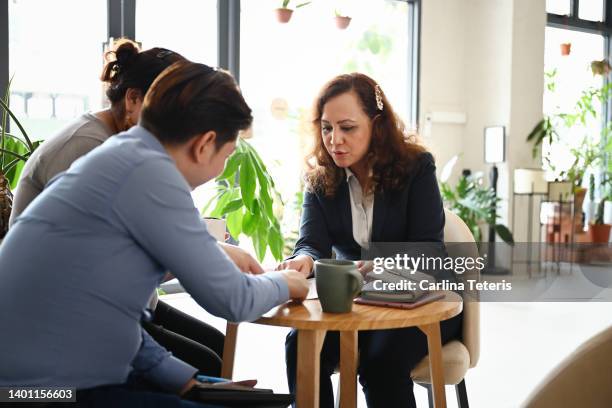 banker meeting with her clients - malay couple stock pictures, royalty-free photos & images