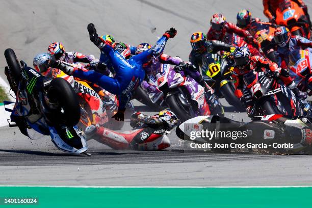 Alex Rins of Spain and Takaaki Nakagami of Japan falling after crashing during the Moto GP of Catalunya at Circuit de Barcelona-Catalunya on June 5,...