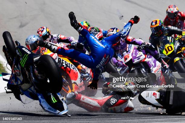 Alex Rins of Spain and Takaaki Nakagami of Japan falling after crashing during the Moto GP of Catalunya at Circuit de Barcelona-Catalunya on June 5,...