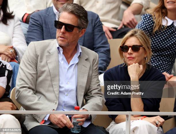Actors Hugh Grant and Sienna Miller are seen in the stands during the Men's Singles Final match between Rafael Nadal of Spain and Casper Ruud of...