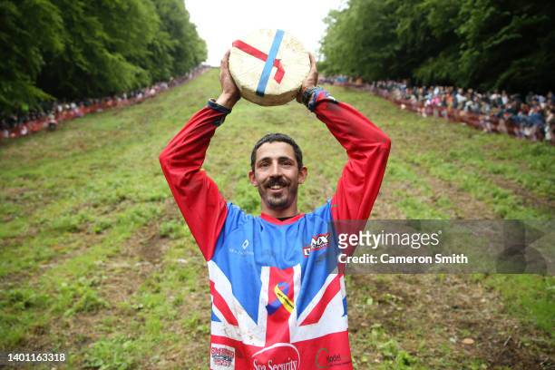 Chris Anderson poses for a photo with the cheese after winning the first man's downhill race on June 05, 2022 in Gloucester, England. The Cooper's...