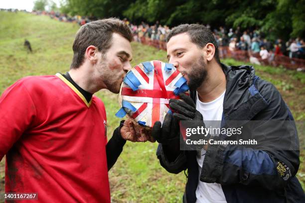 Robbe Gabriels and Amr El Shourbagya kiss the the Jubilee Cheese after their win in the Man's Downhill Jubilee race during the annual Bank Holiday...