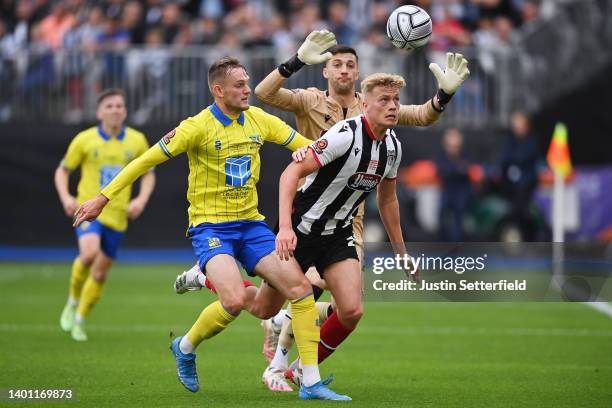 Callum Maycock of Solihull Moors battles for possession with Andy Smith and Max Crocombe of Grimsby Town during the Vanarama National League Final...