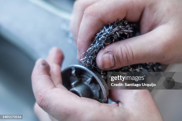 close-up of kid cleaning a kitchen stove - scouring pad stock pictures, royalty-free photos & images