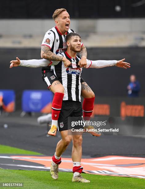 John McAtee celebrates with teammate Jordan Maguire-Drew of Grimsby Town after scoring their team's first goal during the Vanarama National League...