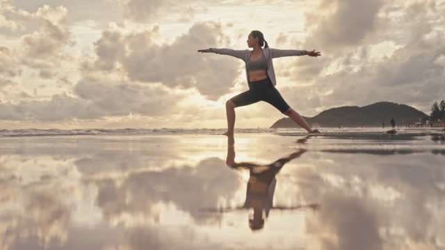 Woman Practicing Yoga at Sunset