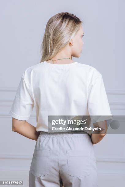 back view woman in white t-shirt and pants portrait close up catalog of clothes for sale - white t shirt - fotografias e filmes do acervo