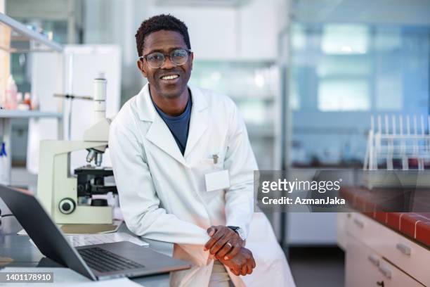 young african-american scientist standing in laboratory - life science stock pictures, royalty-free photos & images