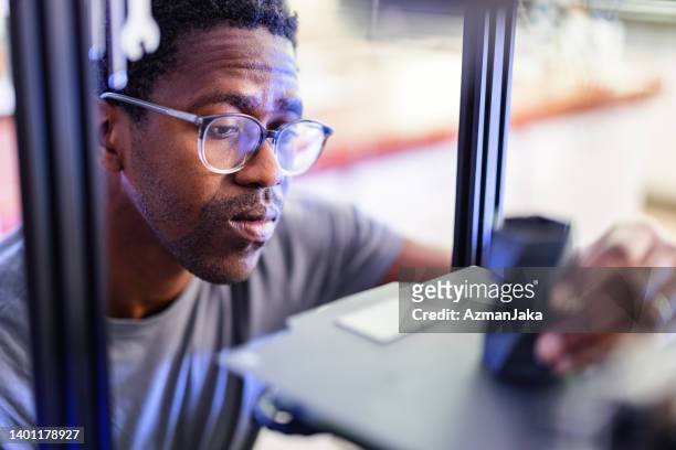 african-american engineer working on a 3d printer - prototype stock pictures, royalty-free photos & images