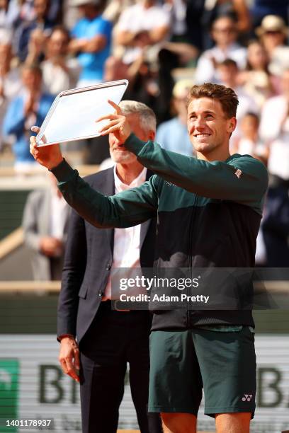 Casper Ruud of Norway poses with the runners up trophy after losing against Rafael Nadal of Spain during the Men's Singles Final match on Day 15 of...