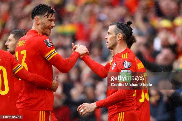 Gareth Bale celebrates with Kieffer Moore of Wales after Andriy Yarmolenko of Ukraine scored an own goal which leads to Wales' first goal during the...