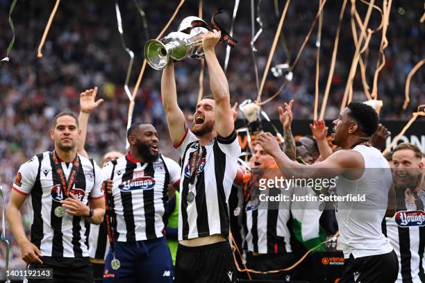 Luke Waterfall of Grimsby Town lifts the Vanarama National League Final trophy after their sides victory during the Vanarama National League Final...
