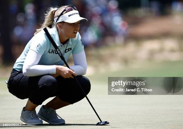 Brooke Henderson of Canada lines up a putt on the first green during the final round of the 77th U.S. Women's Open at Pine Needles Lodge and Golf...