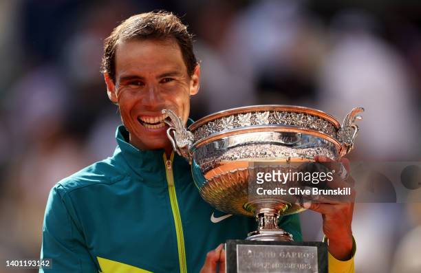 Rafael Nadal of Spain bites the trophy after winning against Casper Ruud of Norway during the Men's Singles Final match on Day 15 of The 2022 French...
