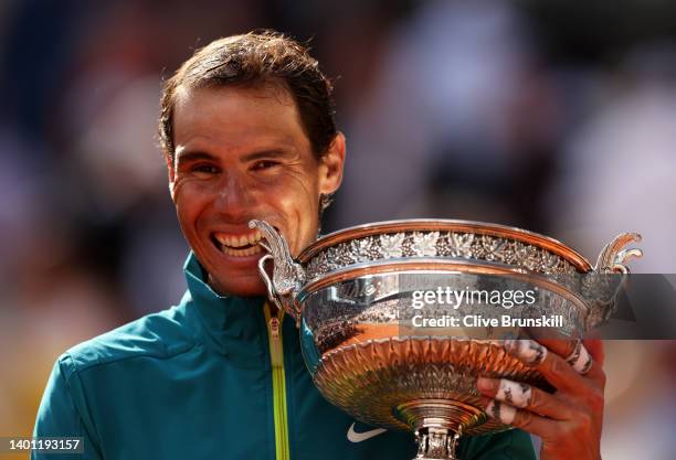 Rafael Nadal of Spain bites the trophy after winning against Casper Ruud of Norway during the Men's Singles Final match on Day 15 of The 2022 French...