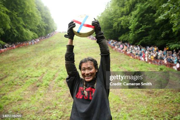 Abby Lampe from North Carolina celebrates her win with the cheese in the woman's race on June 05, 2022 in Gloucester, England. The Cooper's Hill...