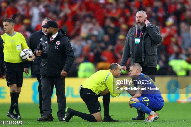 Oleksandr Zinchenko of Ukraine is consoled by referee Antonio Miguel Mateu Lahoz after their sides defeat during the FIFA World Cup Qualifier between...