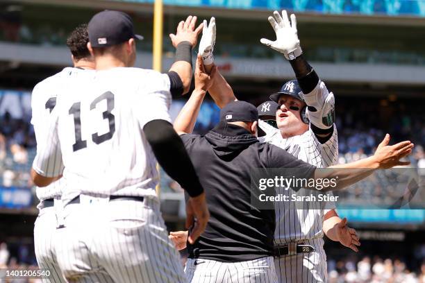 Teammates high-five Josh Donaldson of the New York Yankees after his walk-off sacrifice fly during the tenth inning against the Detroit Tigers at...