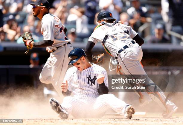 Anthony Rizzo of the New York Yankees reacts after sliding safely into home to score on an error and tie the game during the eighth inning against...