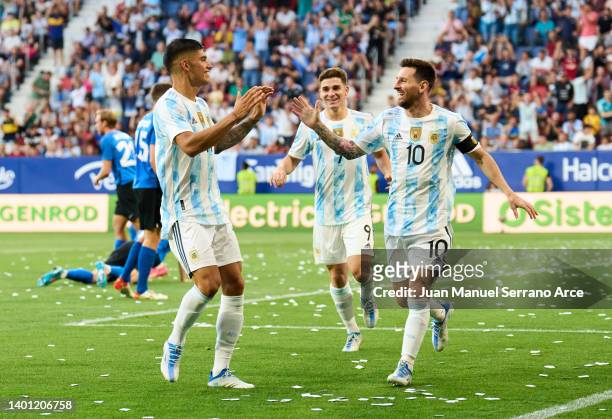 Lionel Messi of Argentina celebrates with his teammates Carlos Joaquin Correa of Argentina after scoring his team's third goal during the...