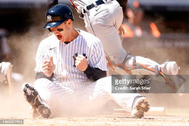 Anthony Rizzo of the New York Yankees reacts after sliding into home on an error to tie the game during the eighth inning against the Detroit Tigers...