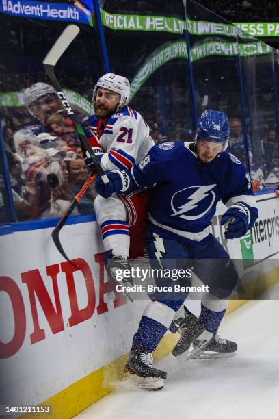 Mikhail Sergachev of the Tampa Bay Lightning checks Barclay Goodrow of the New York Rangers during the first period in Game Three of the Eastern...