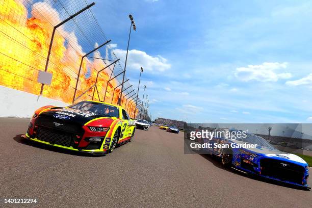 Austin Cindric, driver of the Menards/Atlas Ford, and Chase Briscoe, driver of the HighPoint.com Ford, lead the field on a pace lap prior to the...