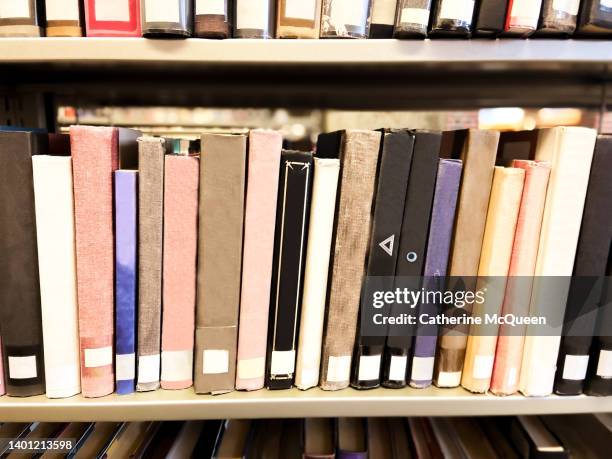 shelves of library books - debt collector stockfoto's en -beelden