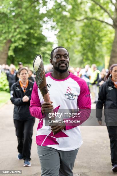 Batonbearer Ebenezer Ayerh carries the Queen’s Baton at Royal Victoria Gardens, during the Birmingham 2022 Queen’s Baton Relay on June 5, 2022 in...