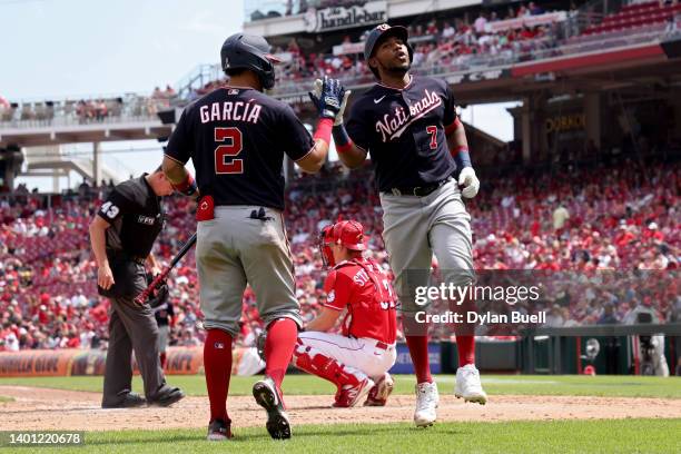 Luis Garcia and Maikel Franco of the Washington Nationals celebrate after Franco hit a home run in the sixth inning against the Cincinnati Reds at...