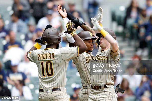 Jake Cronenworth of the San Diego Padres is congratulated after hitting a three run homer in the tenth inning against the Milwaukee Brewers at...