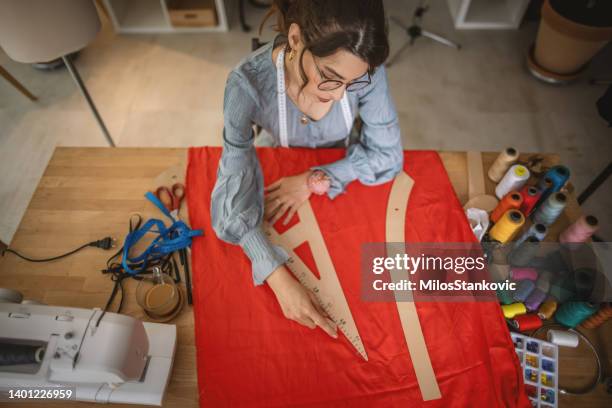 young creative designer in a studio - clothing design studio stock pictures, royalty-free photos & images