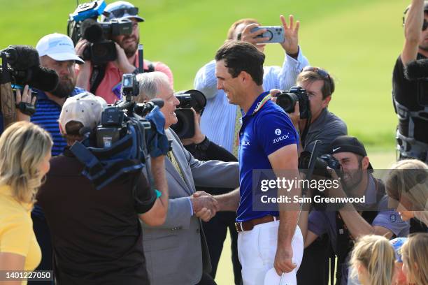 Billy Horschel of the United States shakes hands with Jack Nicklaus on the 18th green after winning the Memorial Tournament presented by Workday at...