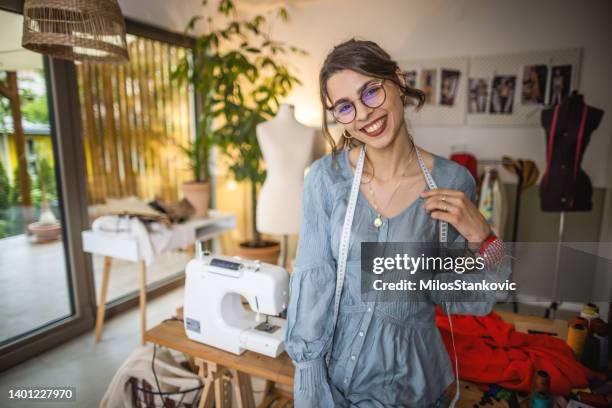 portrait of woman designer standing in her tailor studio - fashion designer sewing stock pictures, royalty-free photos & images