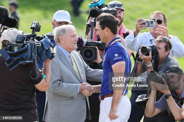 Billy Horschel of the United States shakes hands with Jack Nicklaus on the 18th green after winning the Memorial Tournament presented by Workday at...