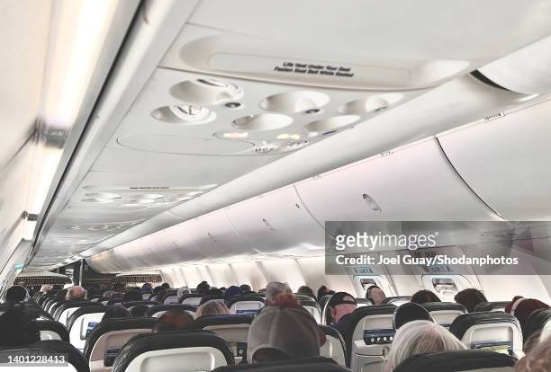 looking the length of inside of airplane - airline passenger stock pictures, royalty-free photos & images