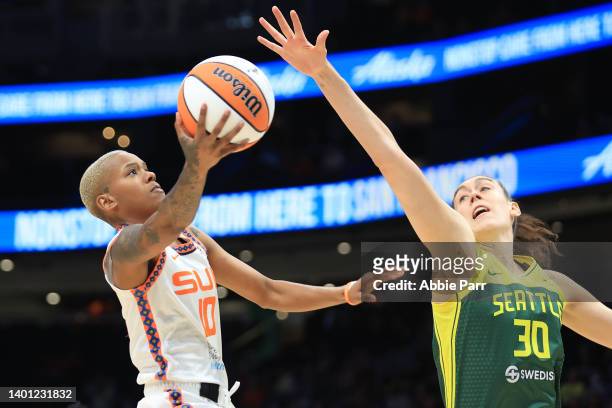 Courtney Williams of the Connecticut Sun attempts a shot against Breanna Stewart of the Seattle Storm during the first quarter at Climate Pledge...