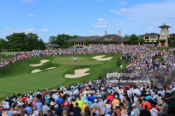 Aaron Wise of the United States and Billy Horschel of the United States look over their putt on the 18th green during the final round of the Memorial...