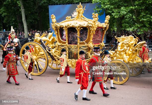 Hologram of Britain's Queen Elizabeth II during her coronation is projected in the Gold State Coach on June 05, 2022 in London, England. The Platinum...