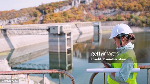maintenance female engineer working in hydroelectric power station. renewable energy systems. - ecologist stock pictures, royalty-free photos & images