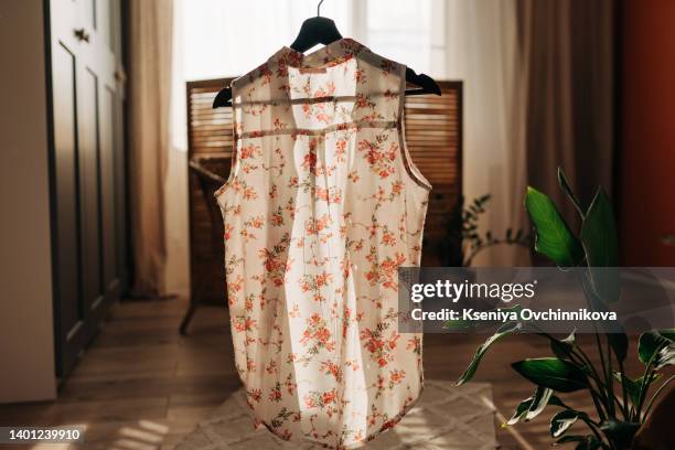 women's aesthetic minimal fashion pastel clothes made of washed linen. stylish female blouses, dresses, pants, shirts on hanger on white background. fashion blog, website, social media - blue dress hanger stock pictures, royalty-free photos & images