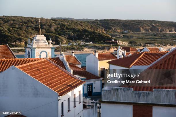 elevated view of tiled rooftops in the town of vila nova de milfontes along the rota vicentina in southwest portugal - alentejo stockfoto's en -beelden